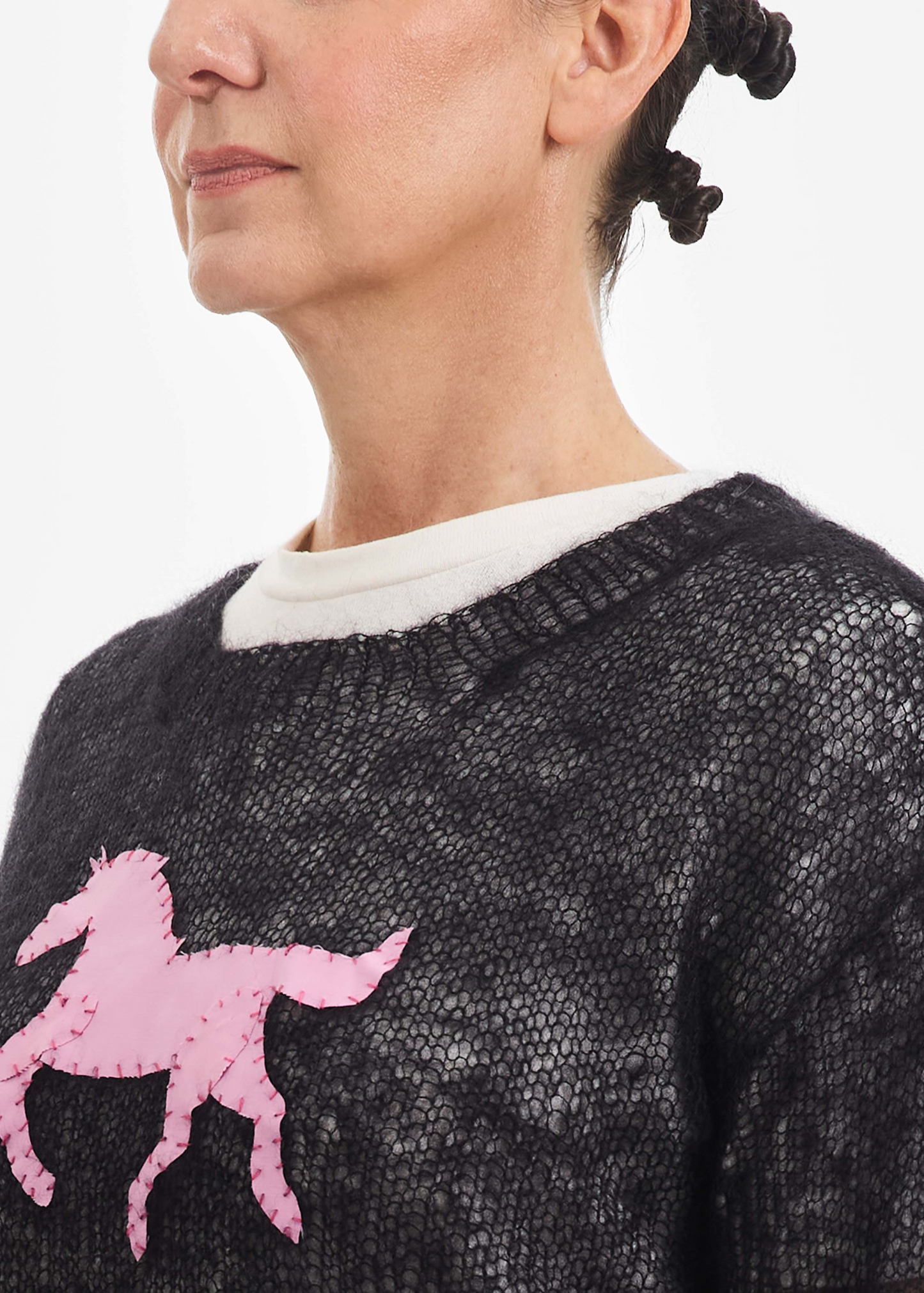 Black sweater, pink pony patch
